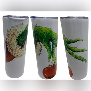 Grinch hand holding red ornament tumbler